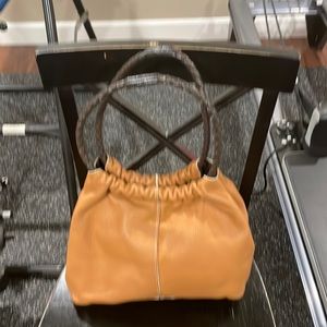 Furla hobo handbag. Pebble grain leather. Brown braided handles.